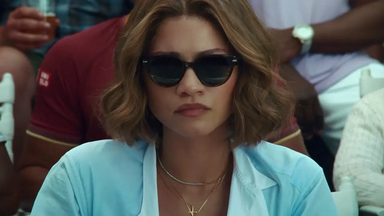 Zendaya observes a tennis match from the crowd stands.