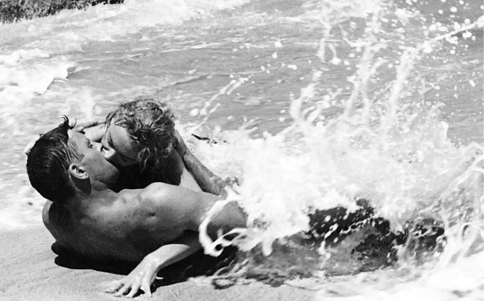 Burt Lancaster and Deborah Kerr have a famous beach encounter.