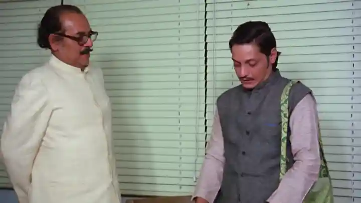 A manager and an interview candidate meet in an office.
