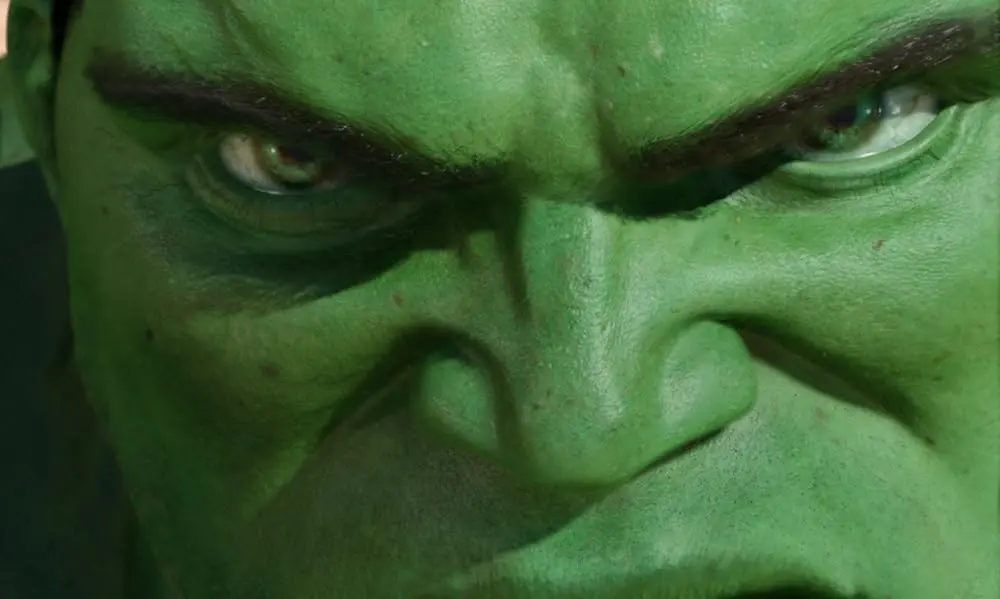 The big green monster looks into the camera in an extreme close-up.