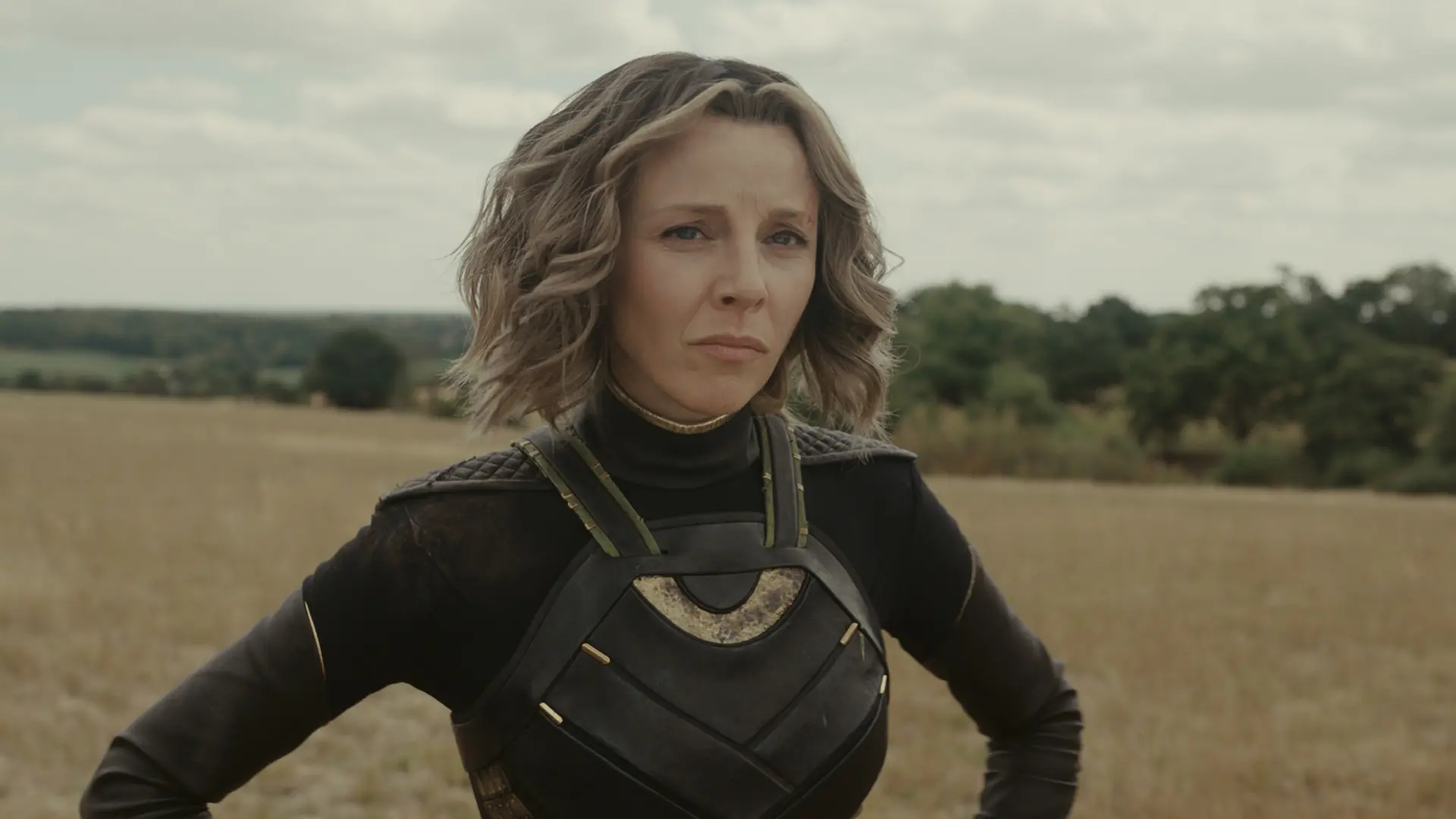 Sylvie (Sophia Di Martino) looks on in a wheatfield.