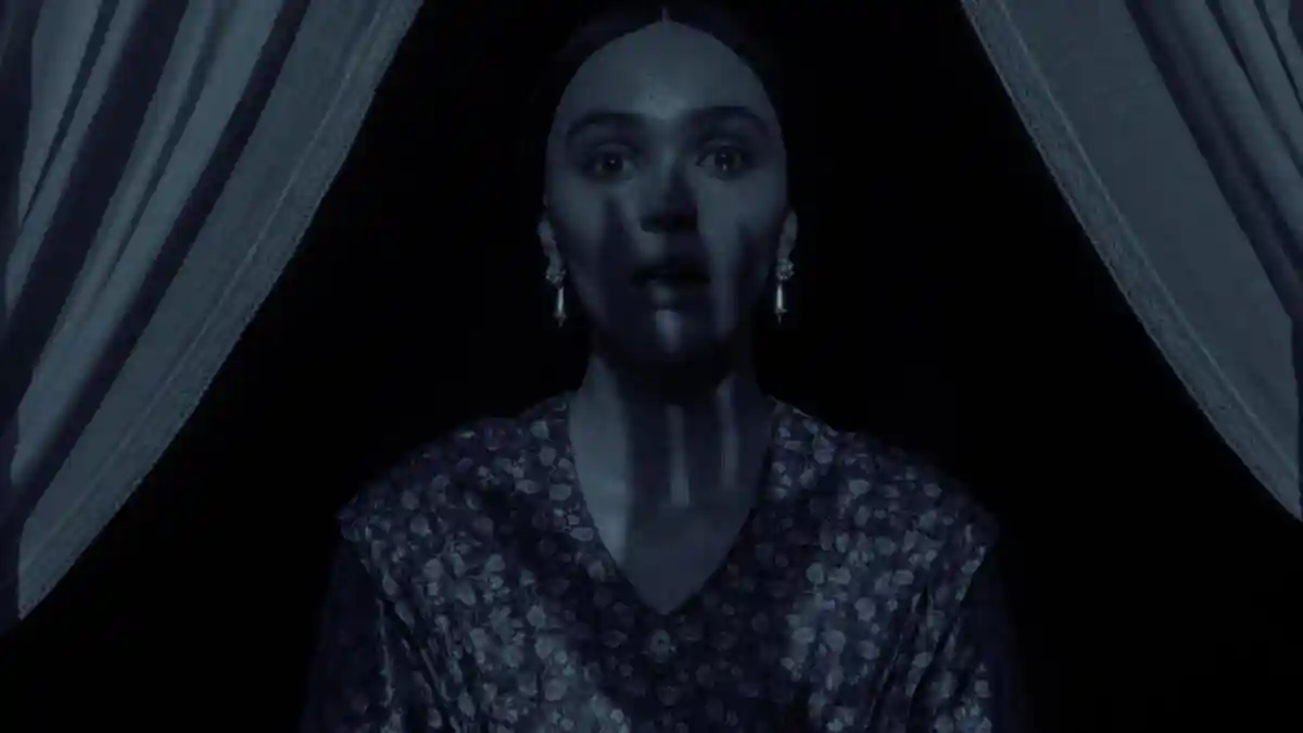 A shadow of a dangerous man is seen on a woman's face.