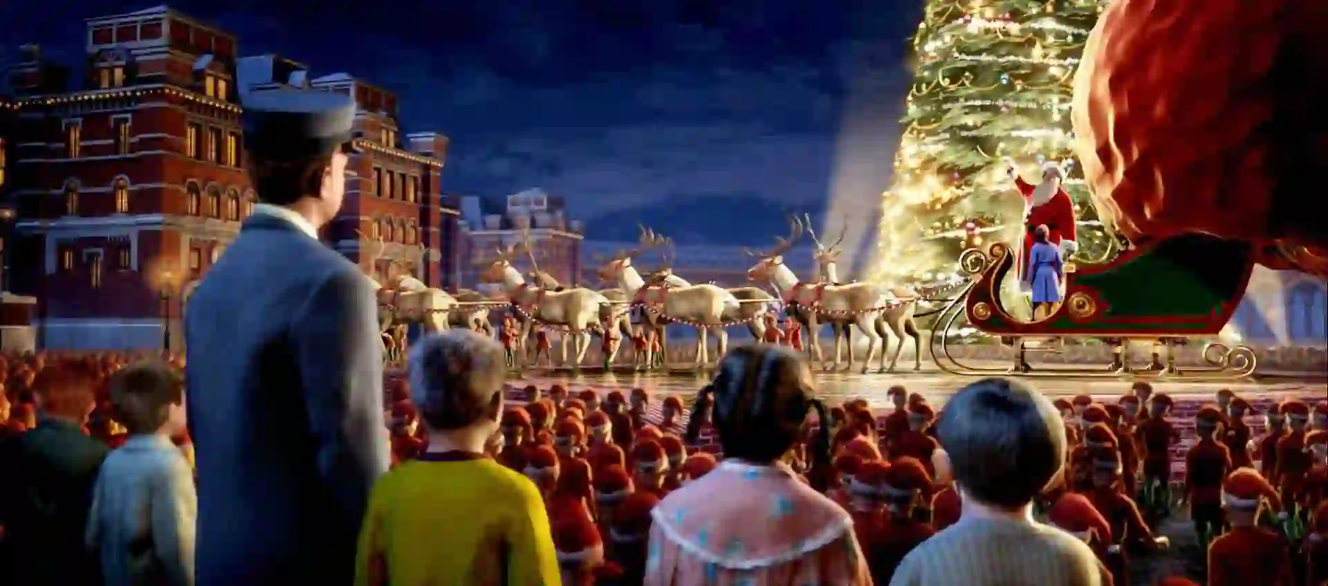 The train conductor and a group of kids look at Santa Claus in the North Pole.