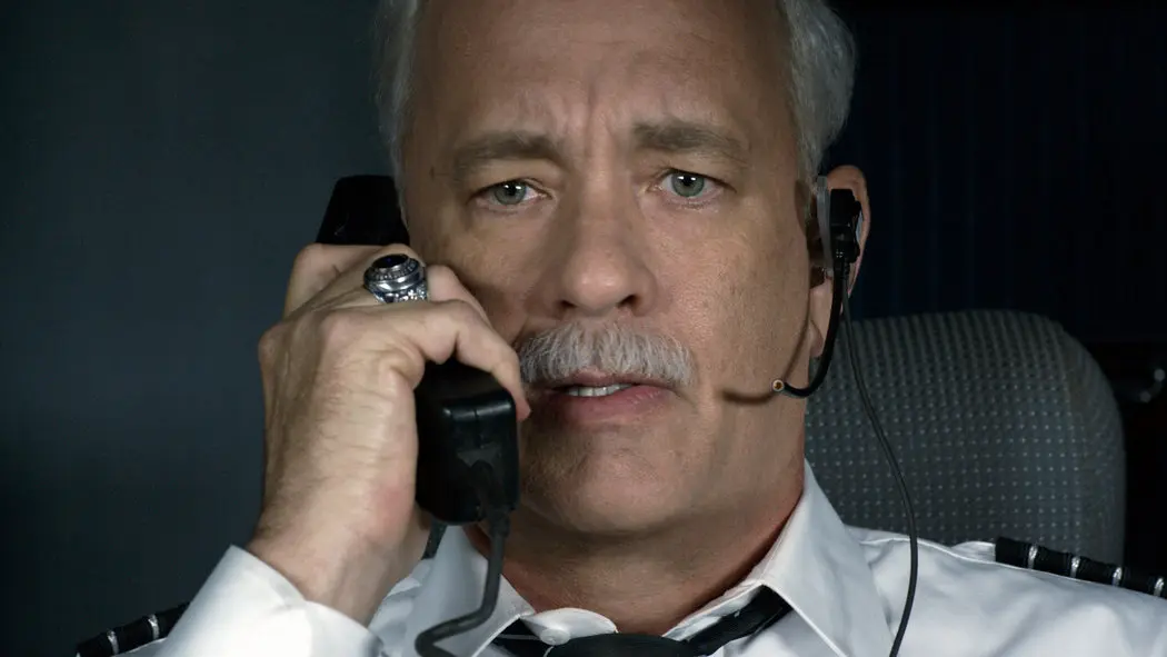Actor Tom Hanks is the pilot, talking over the PA system of an airplane.