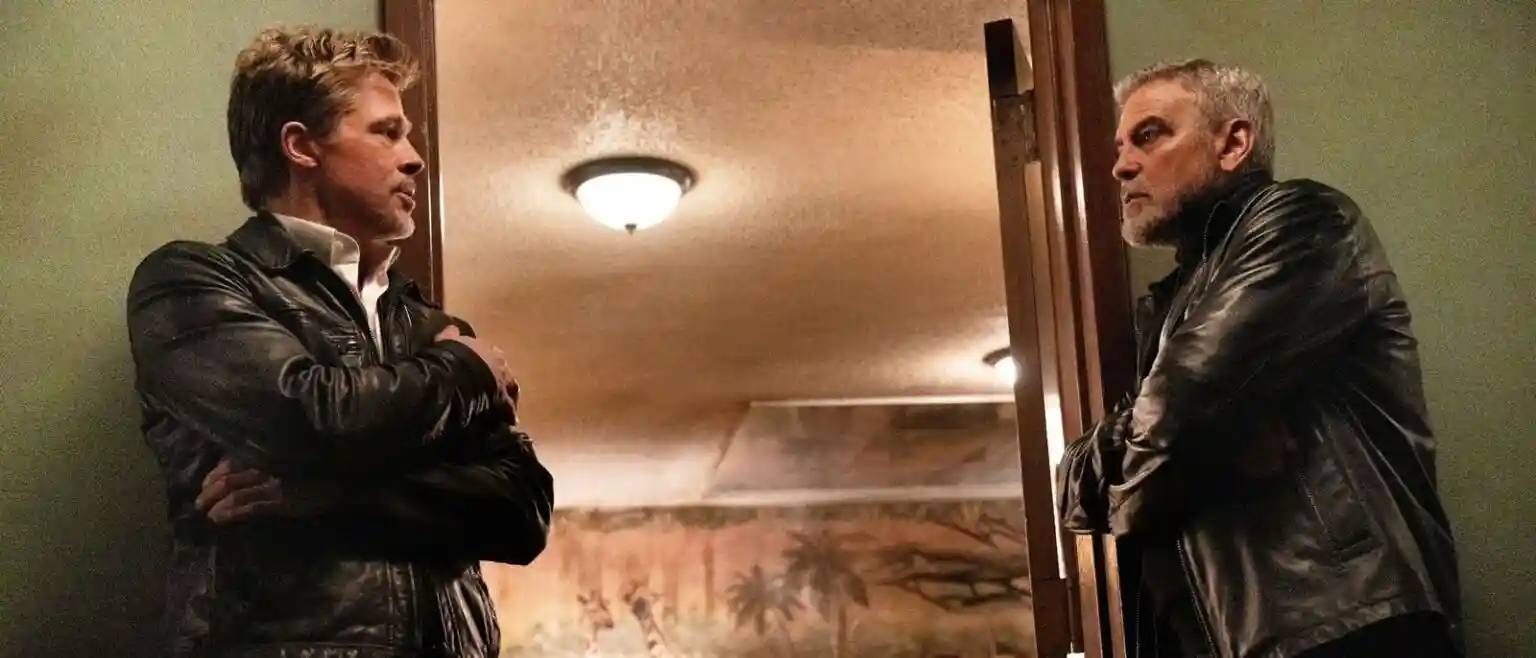 Brad Pitt and George Clooney discuss the situation outside a motel room.